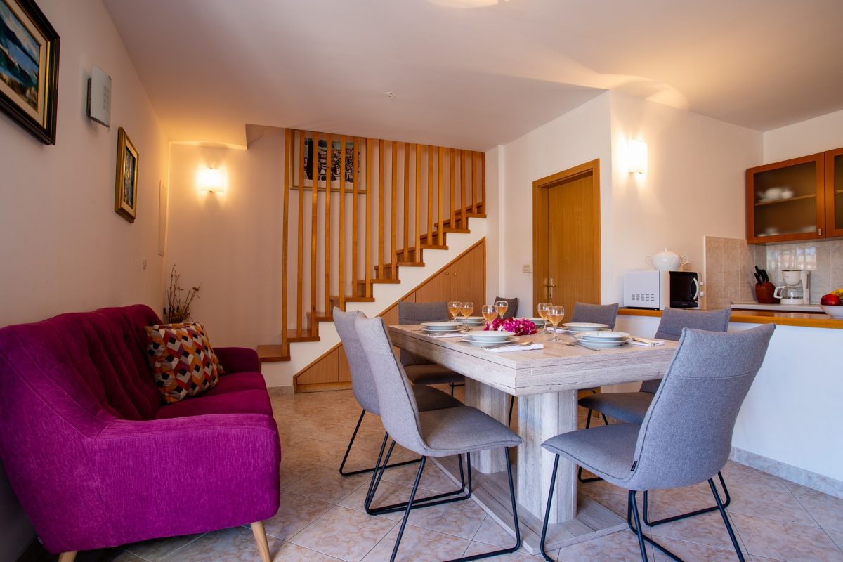 Stylish and modern dining and living room with a served dining table in the Villa Bonaca